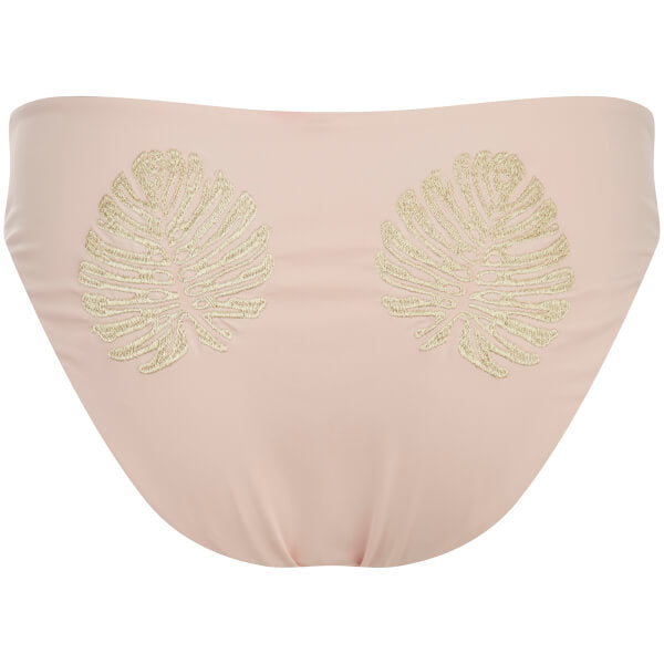 Image shows a Flay lay of the back of Minkpink bikini bottoms in a mid-rise full cut. The gold lure full coverage bottom has a nude colour base with two gold embroidered tropical leaves on the bum.