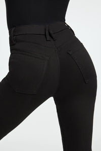 UNIKONCEPT Lifestyle Boutique and Lounge; Model wearing Good American Good Classic Crossover Waistband Jeans in Black001