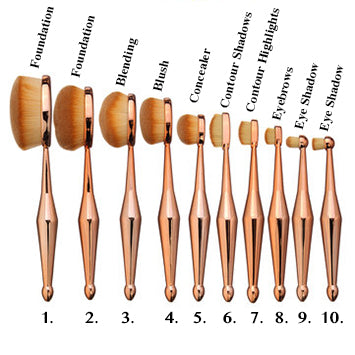Image shows a variety of multipurpose makeup brushes with rose gold bases and thick oval bristle heads 