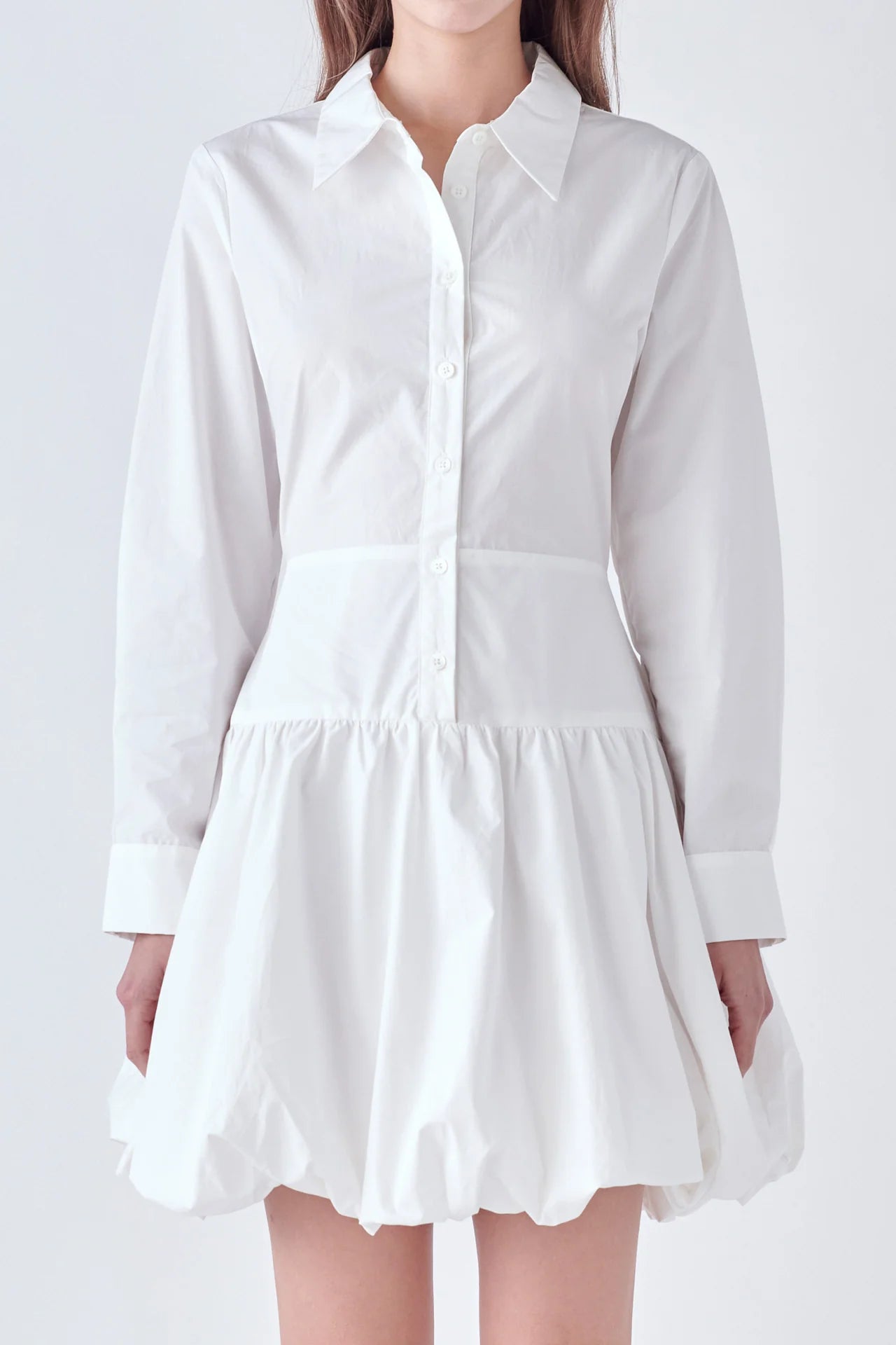 Photo of model wearing Poppy Poplin Button Up Dress in White With bubble skirt, button detailing, and collar available at UniKoncept in Waterloo close up front view