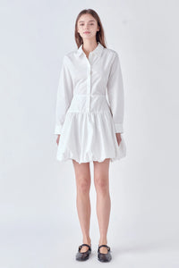 Photo of model wearing Poppy Poplin Button Up Dress in White With bubble skirt, button detailing, and collar available at UniKoncept in Waterloo front view