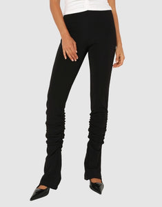 Photo of model wearing Dominique Gathered pants in black with back slit detail available at UniKoncept in Waterloo front view