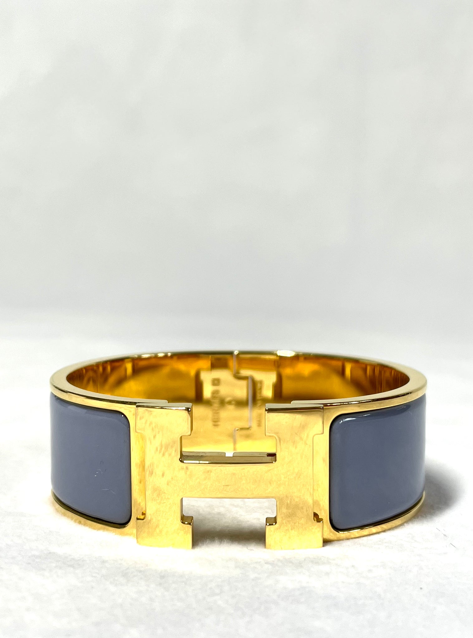 Pre Loved Hermes Clic H Cliquetis Bracelet in gold and blueish grey available at UniKoncept in Waterloo