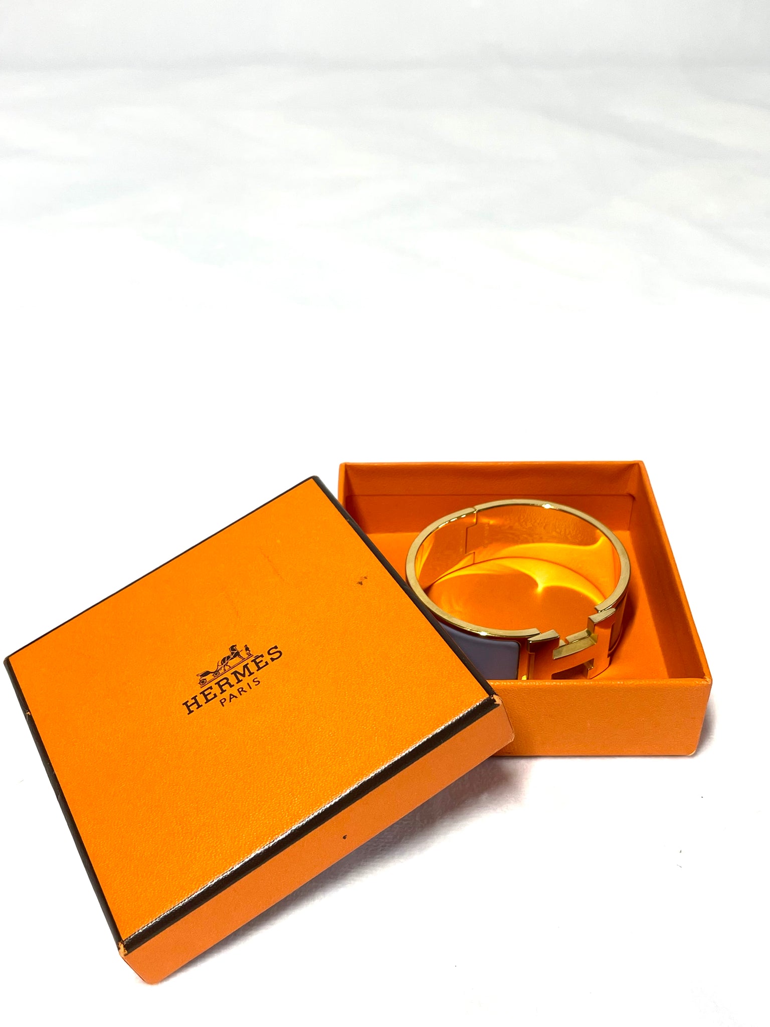 Pre Loved Hermes Clic H Cliquetis Bracelet in gold and blueish grey available at UniKoncept in Waterloo