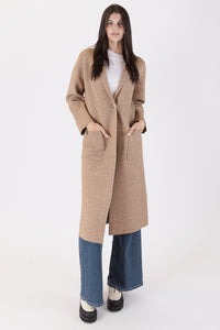Photo of model wearing Judith Long Knit Coat in a camel colour with a button detail available at UniKoncept in Waterloo front view