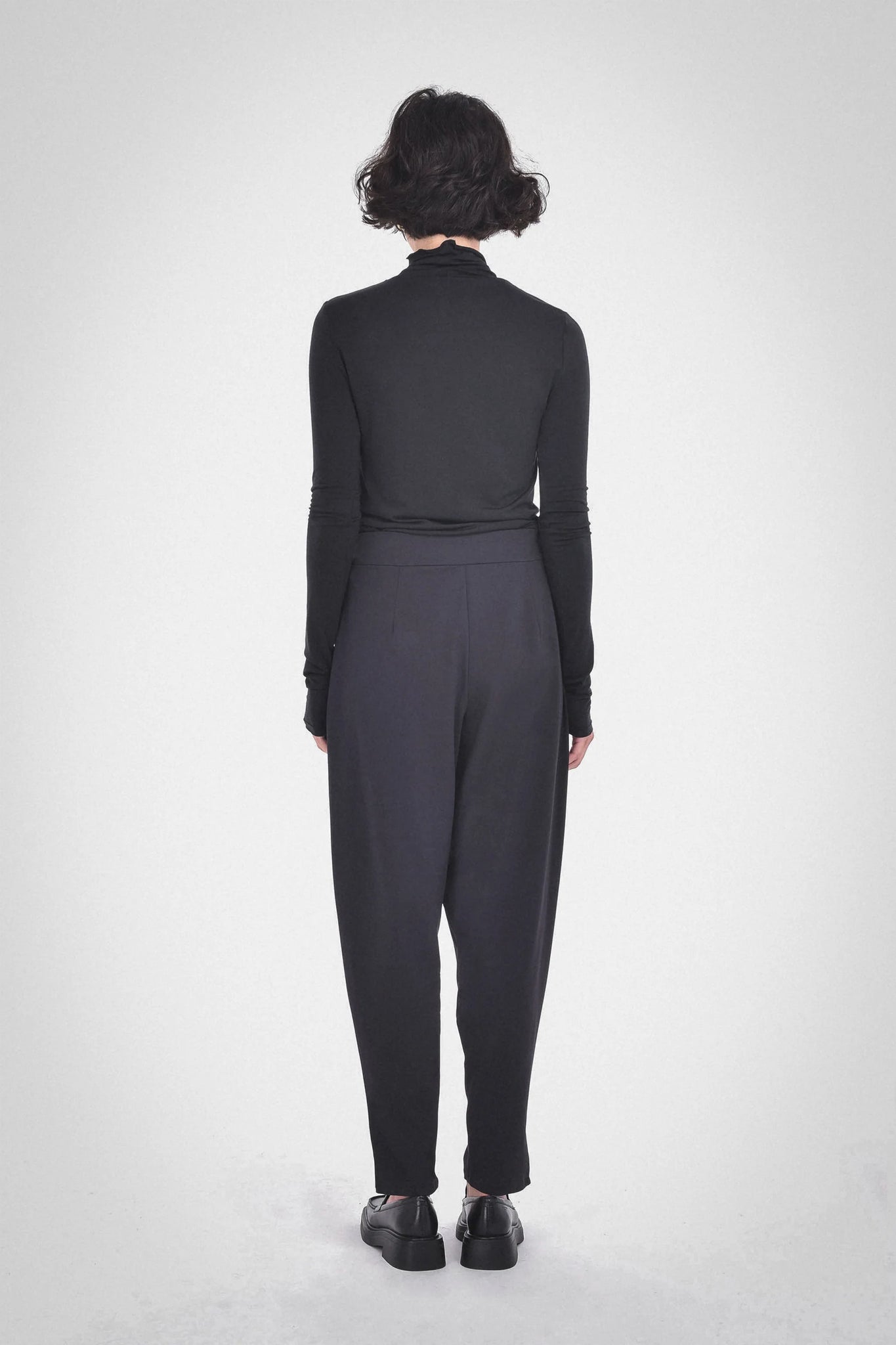 photo of model wearing Galvan A-Symmetrical Pants in black from paper label available at UniKoncept in Waterloo back view