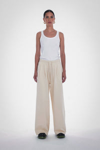 Photo of Model wearing Wen Pleated Pants in an oatmeal colour with pleated wide leg detailing and drawstring from Paper the Label available at UniKoncept in Waterloo - Front View