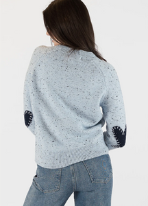 Photo of model wearing Phillipa heart crew neck in light blue with heart patch detailing on the elbows available at UniKoncept in Waterloo