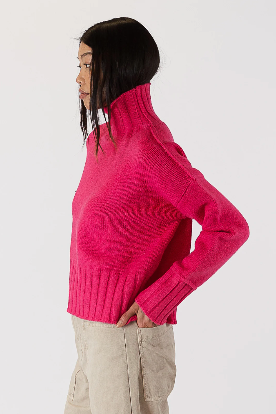 Photo of model wearing Calli Sweater in a hot pink colour featuring a mock neck available at UniKoncept in Waterloo side view