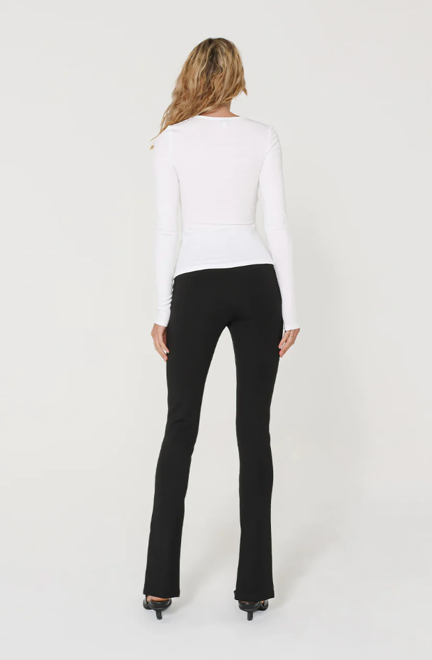 photo of model wearing gretal long sleeve top in white with cross over detailing on the bust available at UniKoncept in Waterloo back view