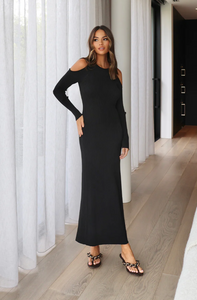 Photo of model wearing evelyn knit dress with a maxi length in the colour black with cut out shoulder details available at UniKoncept in Waterloo