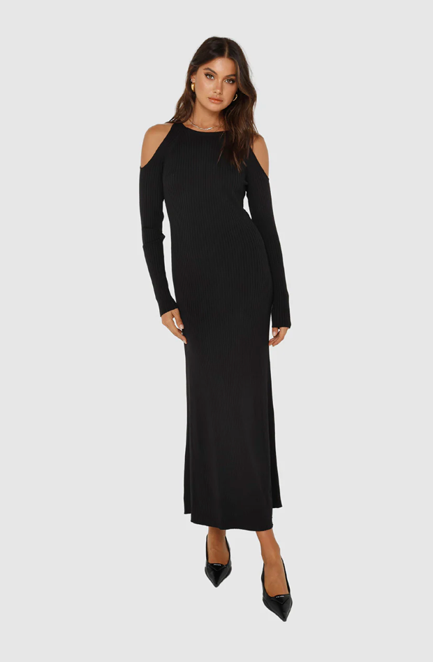 Photo of model wearing evelyn knit dress with a maxi length in the colour black with cut out shoulder details available at UniKoncept in Waterloo front view