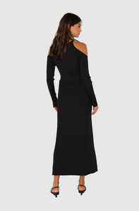 Photo of model wearing evelyn knit dress with a maxi length in the colour black with cut out shoulder details available at UniKoncept in Waterloo back view