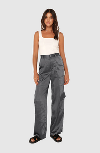 Photo of model wearing addison pants in a dark charcoal grey colour with side pocket details available at UniKoncept in Waterloo front view