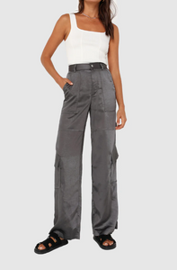 Photo of model wearing addison pants in a dark charcoal grey colour with side pocket details available at UniKoncept in Waterloo front view