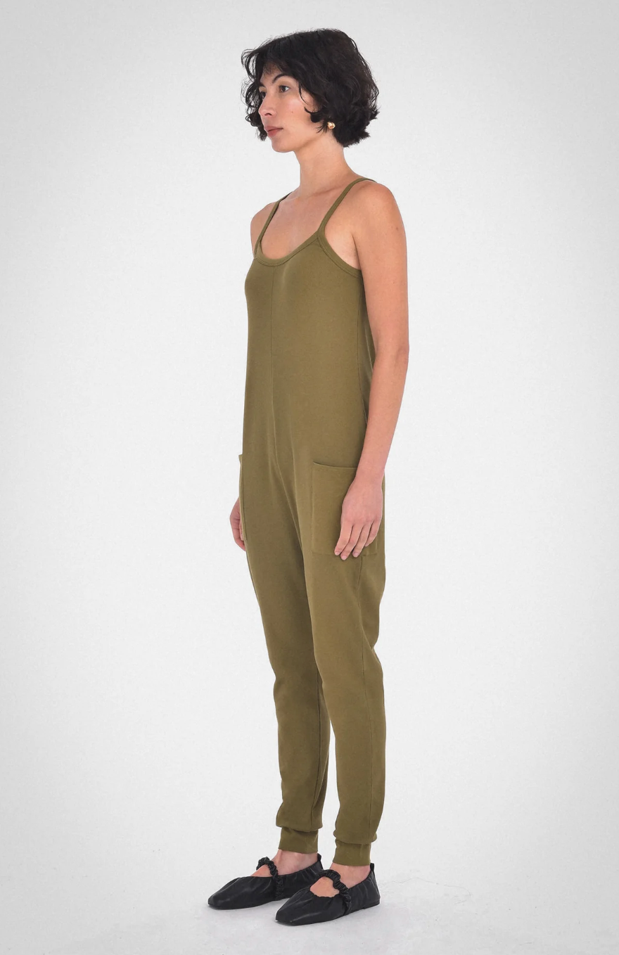 photo of model wearing the nicola jumpsuit in moss from paper label available at UniKoncept in Waterloo side view