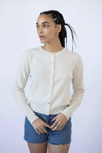 Photo of Model wearing Lyla Cashmere Cardigan featuring buttons up the front in the colour cream puff (cream) available at UniKoncept in Waterloo
