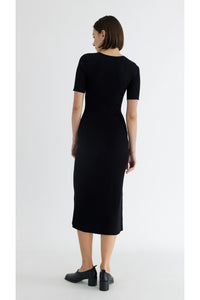 Photo of model wearing the Jenna dress in black with button details available at UniKoncept at Waterloo