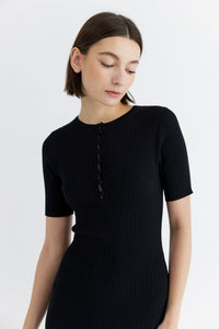 Photo of model wearing the Jenna dress in black with button details available at UniKoncept at Waterloo