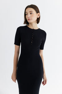 Photo of model wearing the Jenna dress in black with button details available at UniKoncept at Waterloo