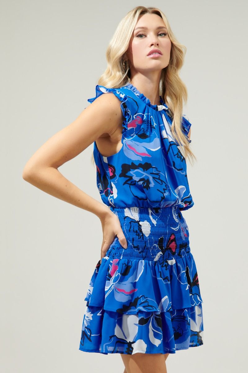 photo of model wearing Katrina dress in blue abstract print with dropped waist detailing available at UniKoncept in Waterloo side view