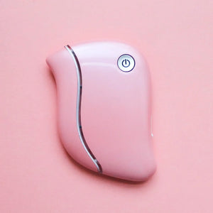 LED Gua Sha Beauty Tool on pink background with cap on