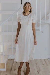 Model is wearing Lovella Ruffle Nursing Dress in Neutral with ruffle details from Roolee available at UniKoncept in Waterloo