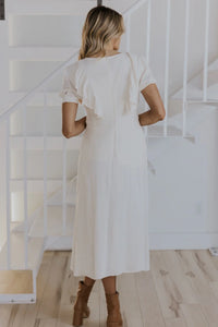 Model is wearing Lovella Ruffle Nursing Dress in Neutral with ruffle details from Roolee available at UniKoncept in Waterloo photo of back view