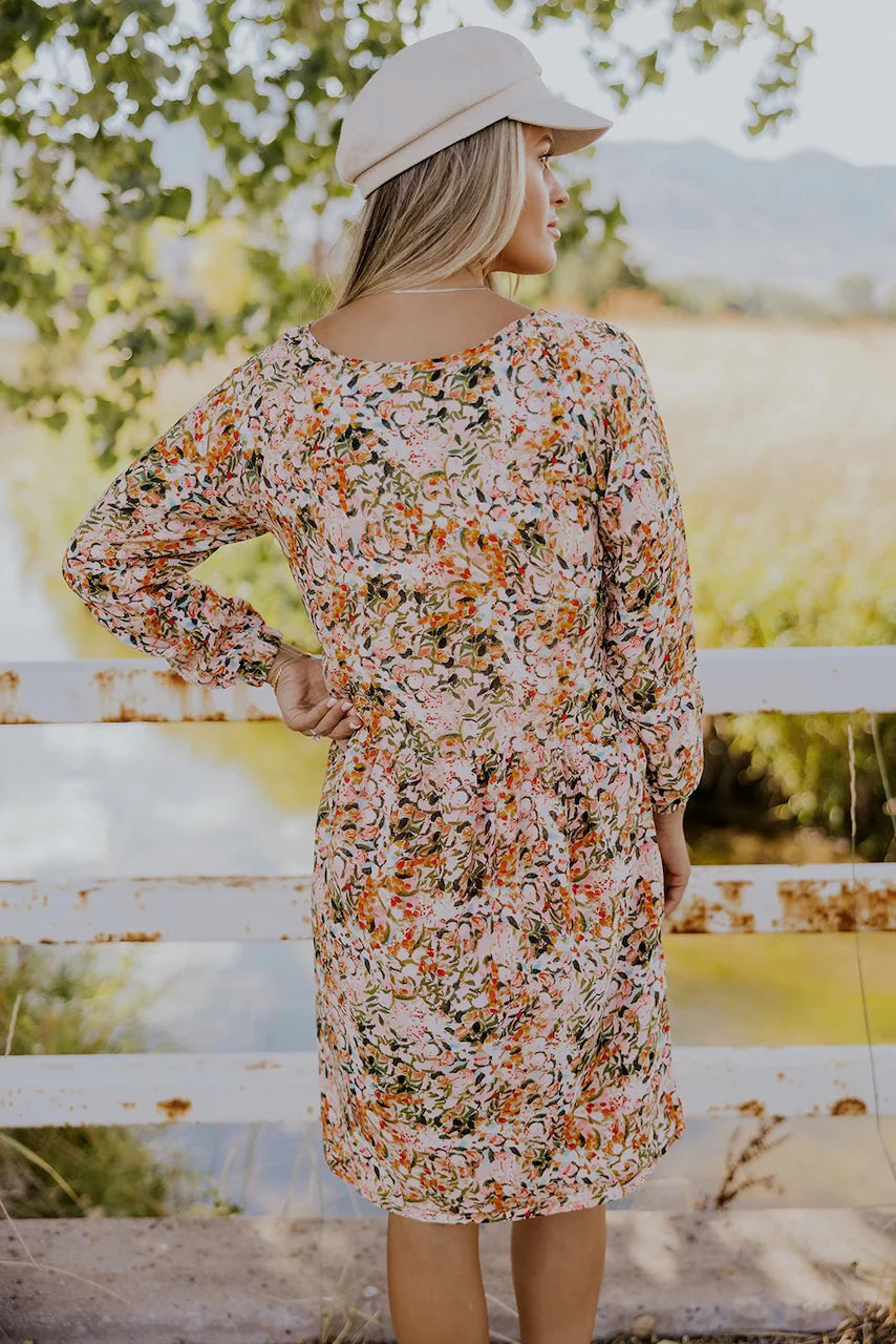 Model wearing Patsy Drop Waist Nursing Dress in floral pattern from Roolee available at UniKoncept in Waterloo photo of back view