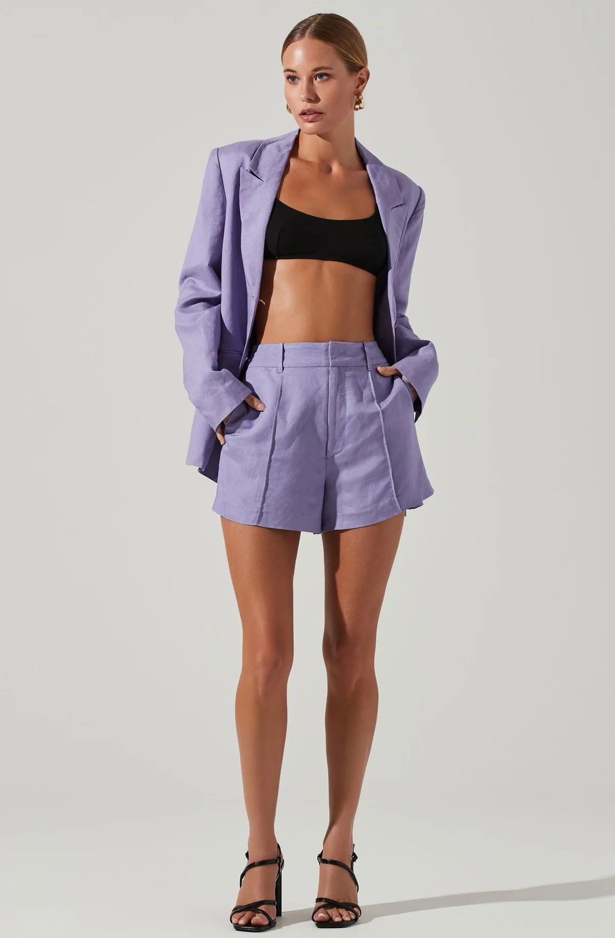 Model wearing Amiah High Waisted Shorts in purple from ASTR The Label available at UniKoncept in Waterloo