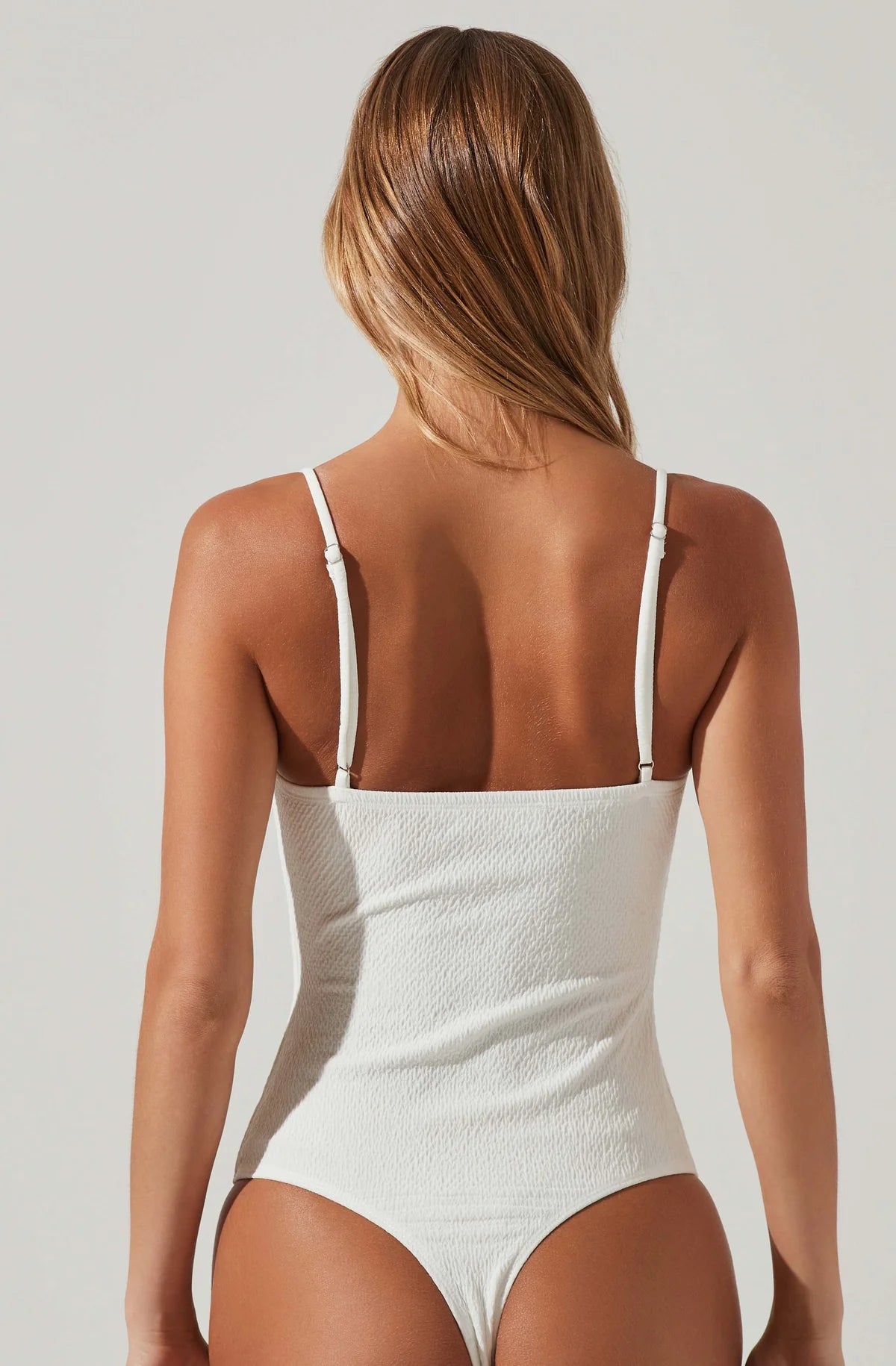 Model wearing Fia Crinkled Plunge Bodysuit in White from ASTR The Label available at UniKoncept in Waterloo back view