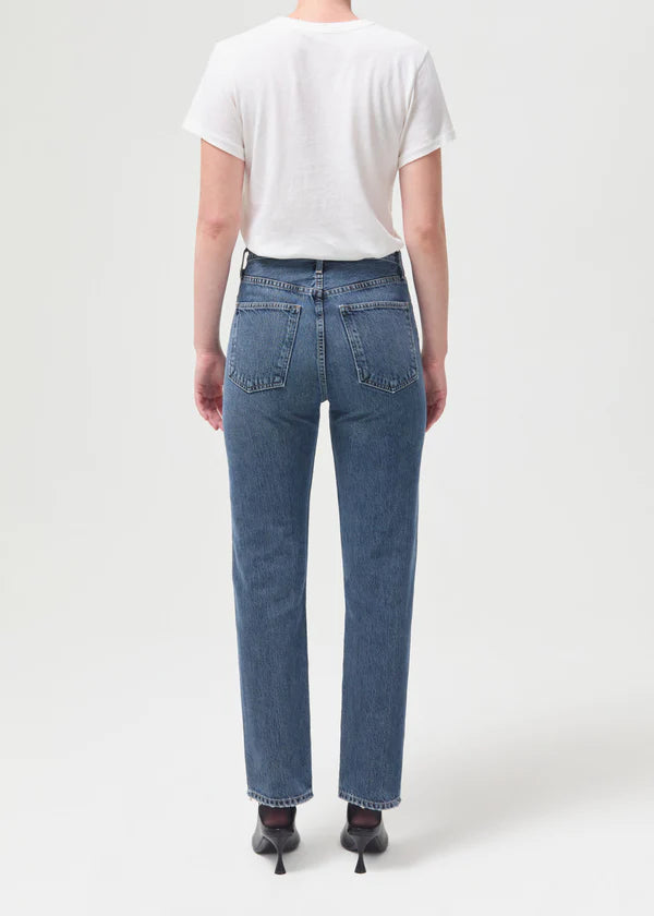Back-facing view of model wearing Agolde 90's Pinch Waist Jeans in Portrait