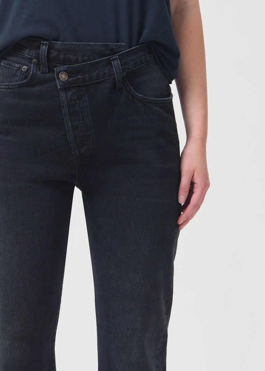 Close-up view of Model wearing Agolde Criss Cross Straight Jeans in Shambles