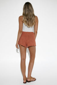 Model wearing Amy Knit Shorts in Brick by Lost in Lunar