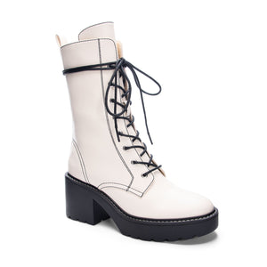 3/4 view of Chinese Laundry Harker Bootie: A white, vegan leather lace-up heeled bootie.
