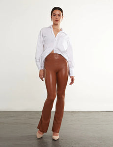 UNIKONCEPT Lifestyle Boutique and Lounge; Commando Faux Leather Flare Legging in Cocoa pictured on a model