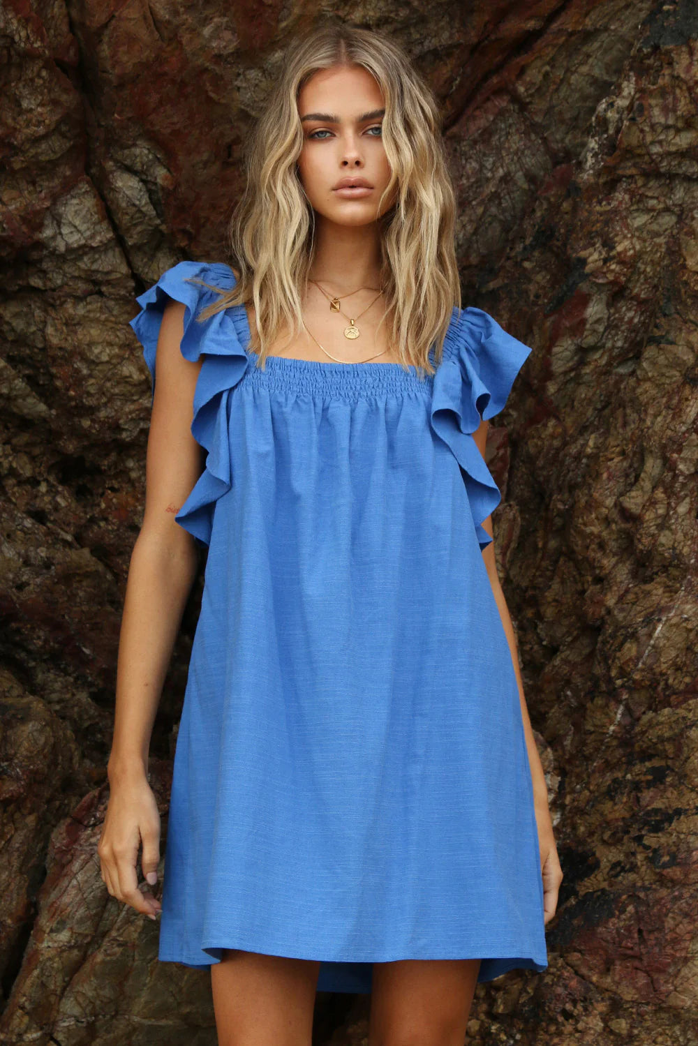Model is wearing Essie dress from Lost in Lunar in blue with shoulder ruffle details available at UniKoncept in Waterloo