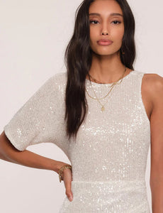 UNIKONCEPT Lifestyle Boutique and Lounge; Close-up view of model wearing Heartloom Pomelo Dress in the colour "Ice": A white sequinned one-sleeve cocktail dress.