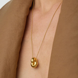 Model wearing Jenny Bird Tome Pendant in High Polish Gold