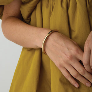 UNIKONCEPT Lifestyle Boutique and Lounge; Model wearing Jenny Bird Gia Bangle in High Polish Gold