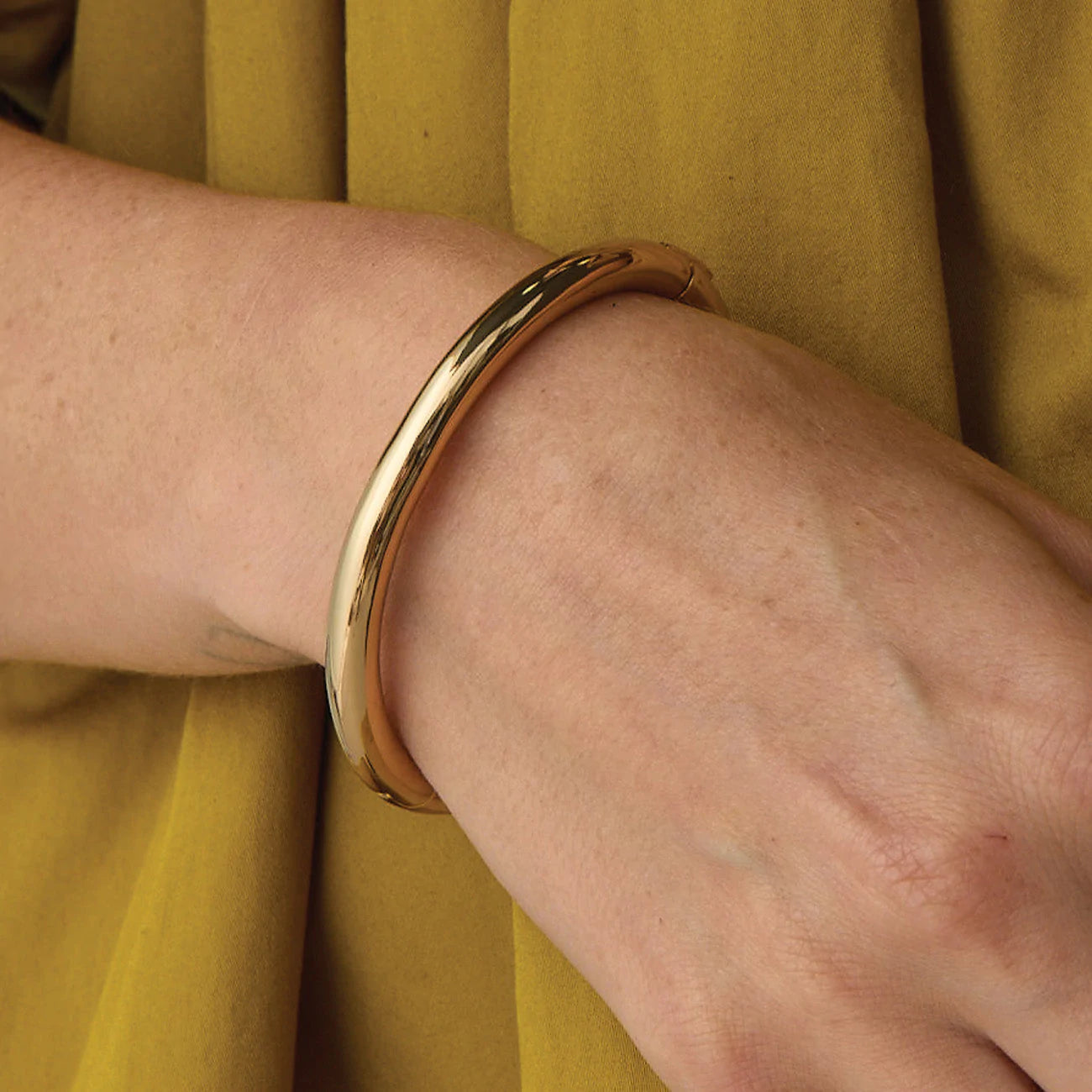UNIKONCEPT Lifestyle Boutique and Lounge;Close up view of model wearing Jenny Bird Gia Bangle in High Polish Gold