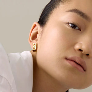 Model wearing Jenny Bird Simone Huggies in High Polish Gold