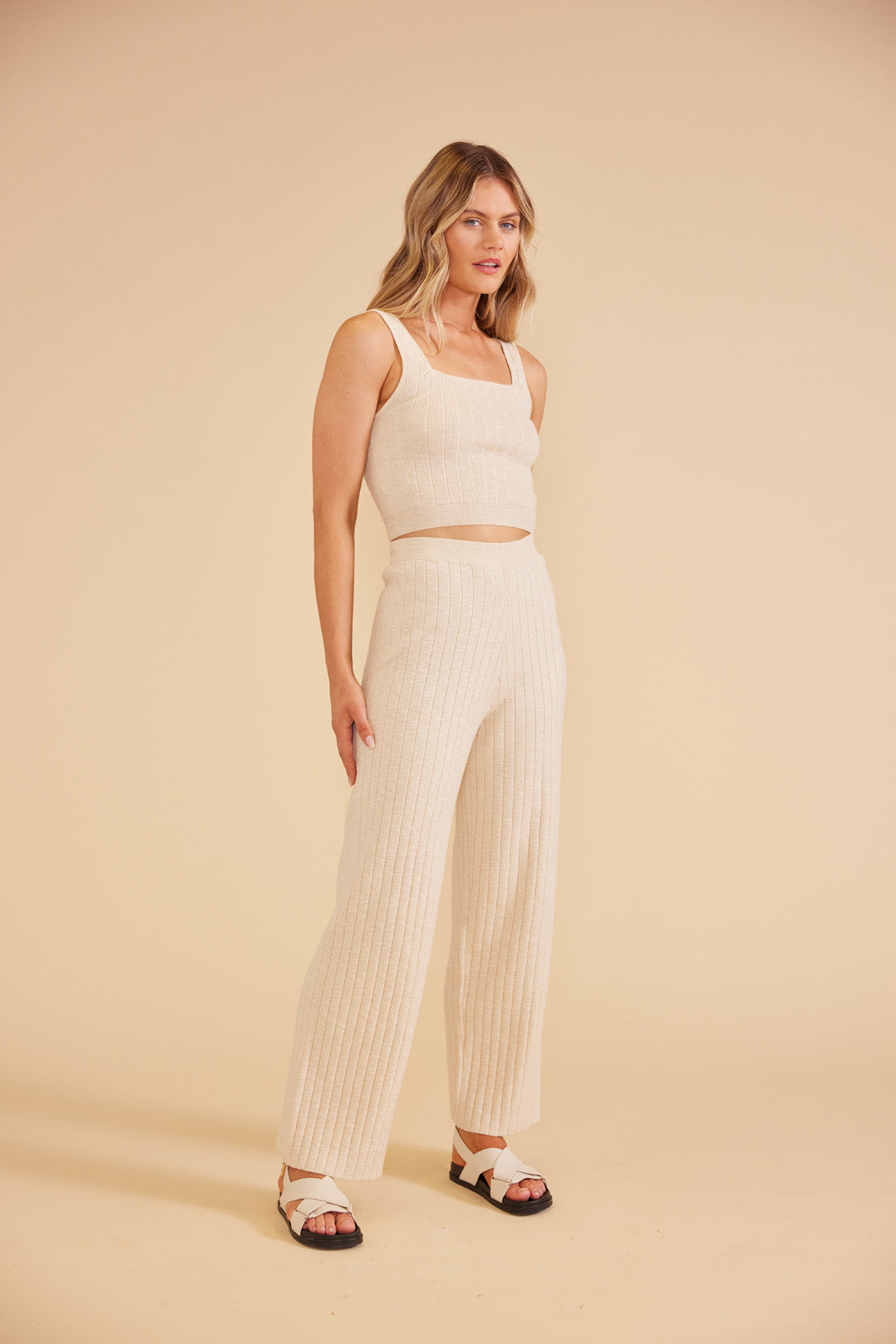 Model wearing Paige Knit Pants in cream from MinkPink available at UniKoncept in Waterloo