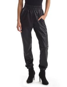 UNIKONCEPT Lifestyle Boutique and Lounge; Commando Faux Leather Smocked Jogger in Black pictured on a model