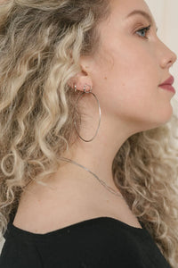 UNIKONCEPT Lifestyle Boutique and Lounge; Model wearing the Miley Large Hoops by Sarah Mulder in Rhodium Rose Quartz