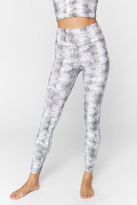 UNIKONCEPT Lifestyle boutique: Image shows the essential HW leggings by Spiritual Gangster. These ultra flattering highwaisted leggings come in a grey snake print.