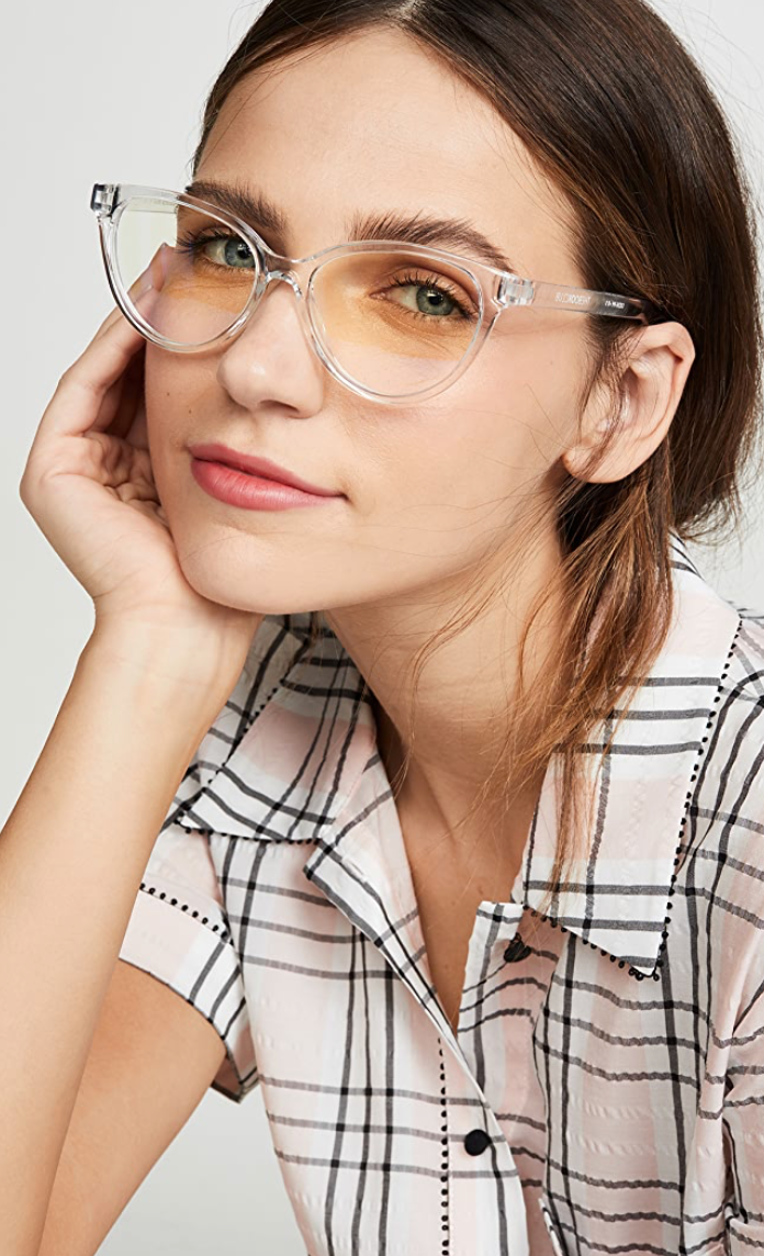 UNIKONCEPT Lifestyle Boutique and Lounge; The Book Club The Art of Snore blue light glasses. Clear, subtle cat eye frames with blue light lenses. Pictured on a model