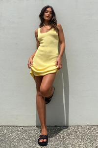 Model is wearing Ellidy Knit Dress in Lemon from Madison The Label available at UniKoncept in Waterloo