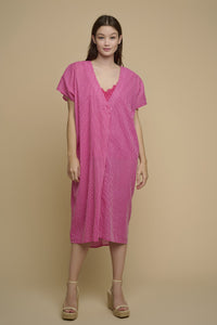 Model is wearing Tuvana Cover Up in pink stripe from rino and pelle
