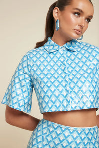  UNIKONCEPT Lifestyle Boutique and Lounge: Model is wearing Tahlia Button Up Crop, a cropped mid-sleeve collared button up with a blue and white sequined diamond pattern throughout